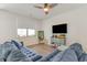 Living room with a ceiling fan, light blue couch, and a large window at 1804 Castlebay Dr., Conway, SC 29526