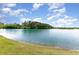 Scenic view of a pond with clear water and a grassy shoreline under a blue sky at 1804 Castlebay Dr., Conway, SC 29526