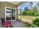Screened porch with plants and a view of the back yard at 1804 Castlebay Dr., Conway, SC 29526