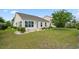 Backyard with landscaping, healthy lawn, yellow planters, and lots of light at 1881 Willowcress Ln., Myrtle Beach, SC 29577