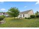 Well-maintained backyard featuring a manicured lawn, mature tree, and tidy landscaping at 1881 Willowcress Ln., Myrtle Beach, SC 29577