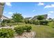 Manicured backyard with lush green grass, landscaping, and mature trees at 1881 Willowcress Ln., Myrtle Beach, SC 29577