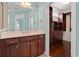 Bathroom with a large mirror, wood vanity with marble top, and a walk-in closet at 1881 Willowcress Ln., Myrtle Beach, SC 29577