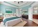 Staged bedroom with hardwood floors, stylish furnishings, and access to ensuite bathroom at 1881 Willowcress Ln., Myrtle Beach, SC 29577