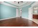Spacious bedroom with tray ceiling, hardwood floors, and access to the bathroom at 1881 Willowcress Ln., Myrtle Beach, SC 29577