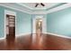 Primary bedroom featuring tray ceilings, hardwood floors, and ensuite bathroom at 1881 Willowcress Ln., Myrtle Beach, SC 29577