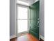 Entryway features a storm door, hardwood floors, and a freshly painted door at 1881 Willowcress Ln., Myrtle Beach, SC 29577