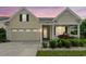Inviting home showcasing a two-car garage, well-lit porch, and manicured landscaping at 1881 Willowcress Ln., Myrtle Beach, SC 29577