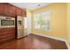Kitchen area with stainless steel appliances, dark wood cabinets, and a large window at 1881 Willowcress Ln., Myrtle Beach, SC 29577