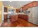 Gourmet kitchen with stainless steel appliances, dark wood cabinets, and a granite-topped island at 1881 Willowcress Ln., Myrtle Beach, SC 29577