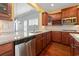 Well-equipped kitchen with stainless steel appliances, dark cabinets, and granite countertops at 1881 Willowcress Ln., Myrtle Beach, SC 29577