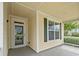 Covered front porch with white trim, green shutters, and a storm door at 1881 Willowcress Ln., Myrtle Beach, SC 29577