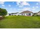Spacious backyard features a well-maintained lawn, mature landscaping, and a patio area perfect for outdoor entertaining at 195 Cupola Dr., Longs, SC 29568