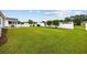 Large, level backyard with a pristine lawn and a white fence, offering plenty of space for recreation and relaxation at 195 Cupola Dr., Longs, SC 29568
