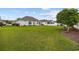 Well-maintained backyard with lush green lawn, white vinyl fencing, and mature trees providing shade and privacy at 195 Cupola Dr., Longs, SC 29568