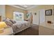 Comfortable bedroom with tray ceiling, window view, and a door leading to another bedroom at 195 Cupola Dr., Longs, SC 29568