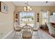 Bright dining area with a round table, white chairs, and a view of the backyard at 195 Cupola Dr., Longs, SC 29568