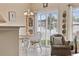 Cozy dining area featuring white chairs and sliding glass doors to the backyard at 195 Cupola Dr., Longs, SC 29568