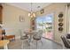 Cozy dining area features a round table, white chairs, and sliding glass doors to a patio with a view at 195 Cupola Dr., Longs, SC 29568