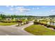 Community entrance with palm trees, brick signage, and well-maintained landscaping, creating a welcoming atmosphere at 195 Cupola Dr., Longs, SC 29568