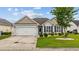 Charming single-story home with a well-manicured lawn and attached two-car garage at 195 Cupola Dr., Longs, SC 29568