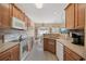 Spacious kitchen with stainless steel appliances and breakfast bar with an open view into the dining area at 195 Cupola Dr., Longs, SC 29568