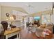 Open-concept living room with hardwood floors, fireplace, and view of dining area at 195 Cupola Dr., Longs, SC 29568