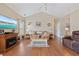 Bright living room featuring hardwood floors, a fireplace, and comfortable seating at 195 Cupola Dr., Longs, SC 29568