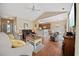 Spacious living room with hardwood floors, comfortable seating, and open flow to dining area at 195 Cupola Dr., Longs, SC 29568