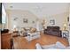 Comfortable living room showcasing hardwood floors, neutral decor, and ample seating at 195 Cupola Dr., Longs, SC 29568