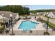 Community pool area with plenty of seating, mature landscaping, and a lifeguard station, perfect for summer relaxation at 195 Cupola Dr., Longs, SC 29568