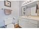 Bathroom with white cabinets, a sink, a mirror, and a toilet at 2090 Cross Gate Blvd. # 202, Surfside Beach, SC 29575