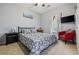 Comfortable bedroom features a queen bed, mounted TV, and large window with curtains at 2090 Cross Gate Blvd. # 202, Surfside Beach, SC 29575