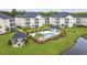 Beautiful community pool surrounded by palm trees, manicured landscaping, and well-maintained apartment buildings at 2090 Cross Gate Blvd. # 202, Surfside Beach, SC 29575