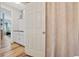 Hallway view into kitchen with white cabinets, a freezer, and a dining set at 2090 Cross Gate Blvd. # 202, Surfside Beach, SC 29575