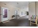 Inviting condo hallway featuring neutral walls, seating and door leading to unit 202 at 2090 Cross Gate Blvd. # 202, Surfside Beach, SC 29575