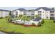 Aerial view of a community pool with cabana and seating area surrounded by lush landscaping at 2090 Cross Gate Blvd. # 202, Surfside Beach, SC 29575