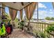 Screened-in porch decorated with various potted plants and outdoor decor at 2090 Cross Gate Blvd. # 202, Surfside Beach, SC 29575
