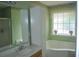 Bathroom with a bathtub and shower combo and vanity with sink and white storage cabinet at 22 Woodhaven Dr. # C, Murrells Inlet, SC 29576