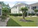 Back yard featuring plush lawns, attractive landscaping, and manicured hedges for an appealing view at 22 Woodhaven Dr. # C, Murrells Inlet, SC 29576