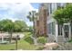 Relaxing condo building with decorative landscaping, a stone-lined creek, and white gravel accents at 22 Woodhaven Dr. # C, Murrells Inlet, SC 29576