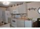 A traditional kitchen featuring bright cabinets, stainless steel appliances, and laminate countertops at 22 Woodhaven Dr. # C, Murrells Inlet, SC 29576
