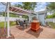 Backyard area with a pergola, outdoor fireplace, table and chairs, and a grill setup, perfect for entertaining at 221 Lander Dr., Conway, SC 29526