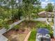 An aerial view of the backyard, highlighting the patio set, well-maintained lawn, and surrounding mature trees at 221 Lander Dr., Conway, SC 29526