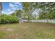 Wide backyard with a small cottage, bordered by a white picket fence, and is surrounded by mature trees and landscaping at 221 Lander Dr., Conway, SC 29526