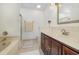 This bathroom features a marble countertop, wood cabinets, and a bathtub with a shower at 221 Lander Dr., Conway, SC 29526
