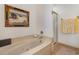 This bathroom features a built-in bathtub, a shower, and a painting of a beach scene at 221 Lander Dr., Conway, SC 29526