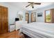 Bright bedroom featuring hardwood floors, white wicker furniture, two windows, and a ceiling fan at 221 Lander Dr., Conway, SC 29526