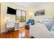 Bright bedroom with hardwood floors, a large window, a white desk, and a mounted TV at 221 Lander Dr., Conway, SC 29526