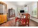 Bright dining room with hardwood floors, shuttered windows, dining table, chairs, and a china cabinet at 221 Lander Dr., Conway, SC 29526